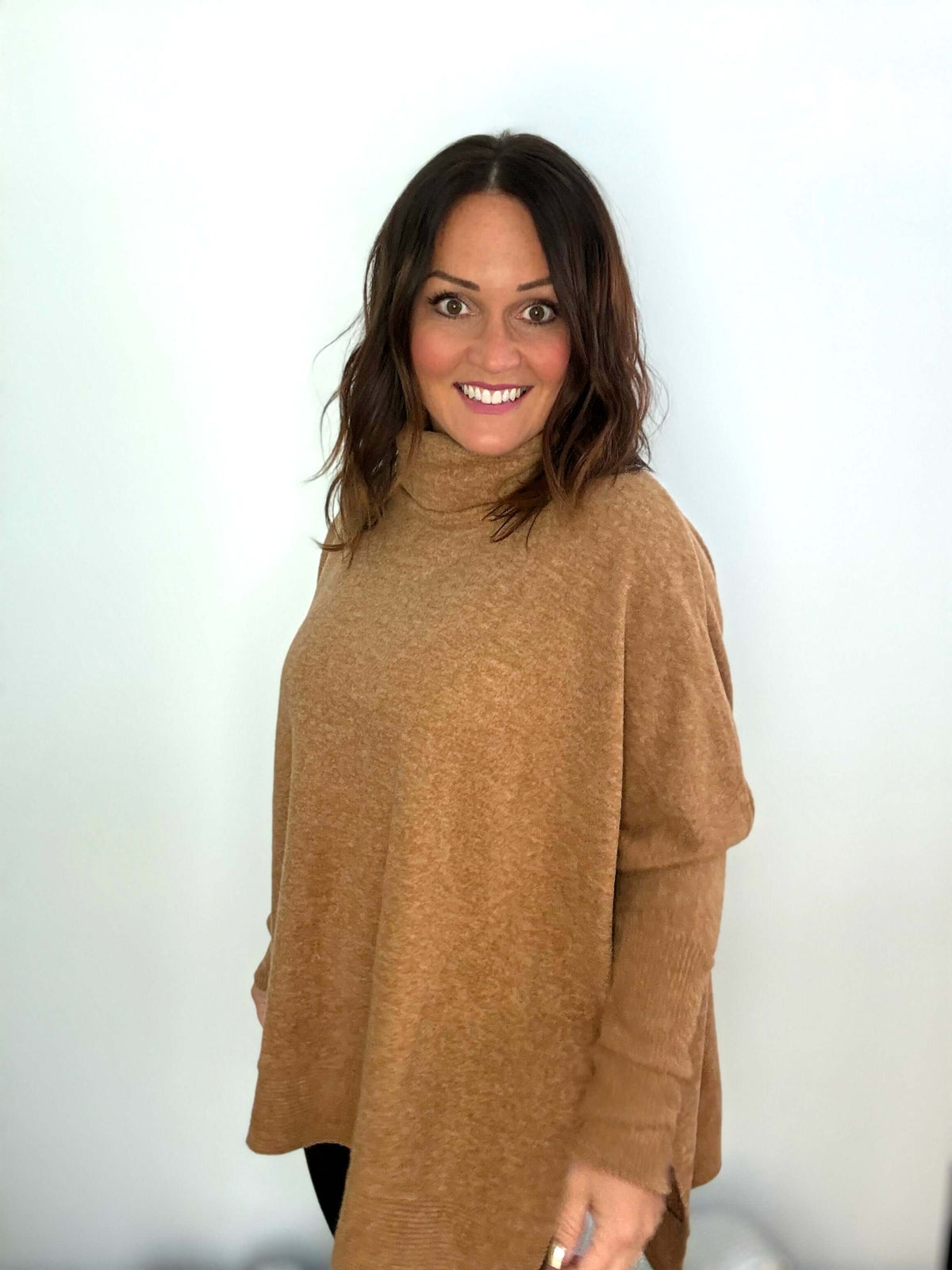 Woman wearing Wine Tasting Cowl Neck Poncho Sweater in deep camel, showcasing elegant and cozy fashion style.