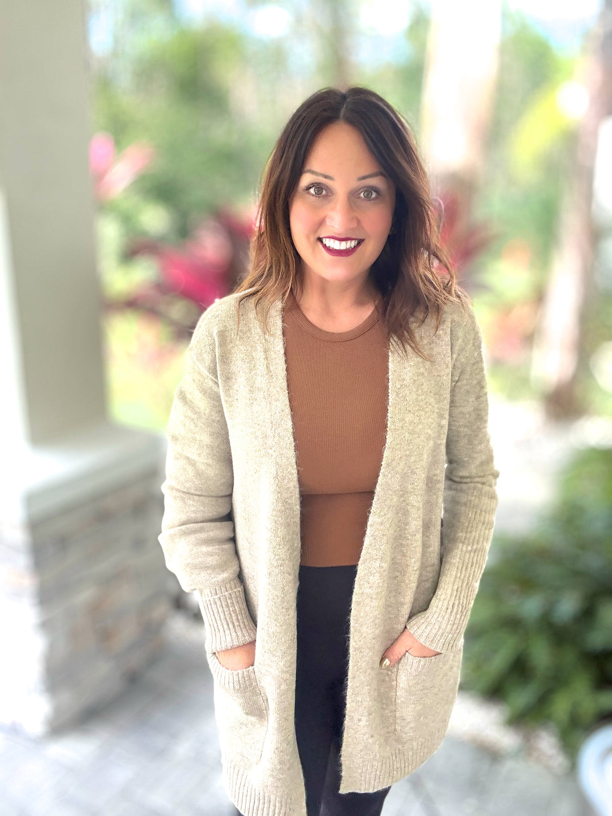 Woman wearing a cozy Autumn Moment Cardigan with front pockets, perfect for fall fashion and warmth.