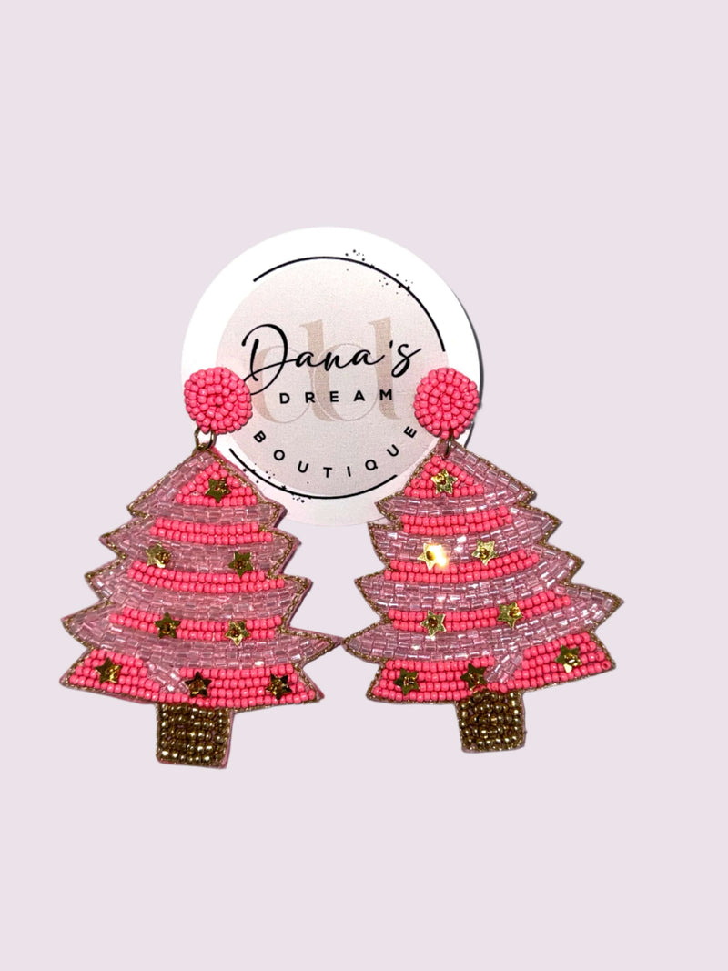 Pink beaded Christmas tree earrings with festive design on a display card from Dana's Dream Boutique.